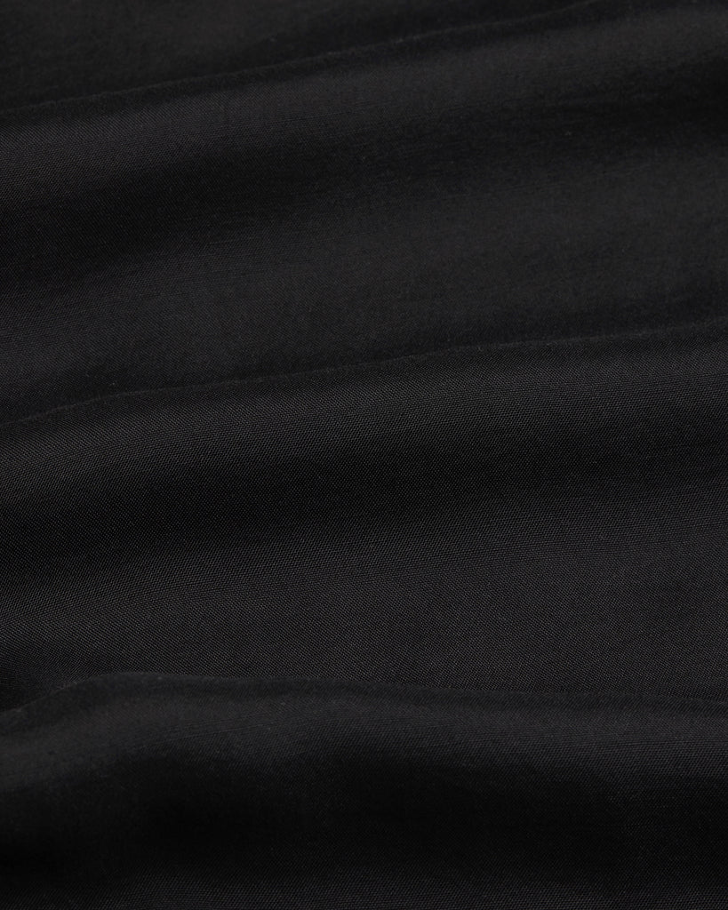 Black Cremona fabric close-up, soft sheer voile made in Europe for luxury resortwear